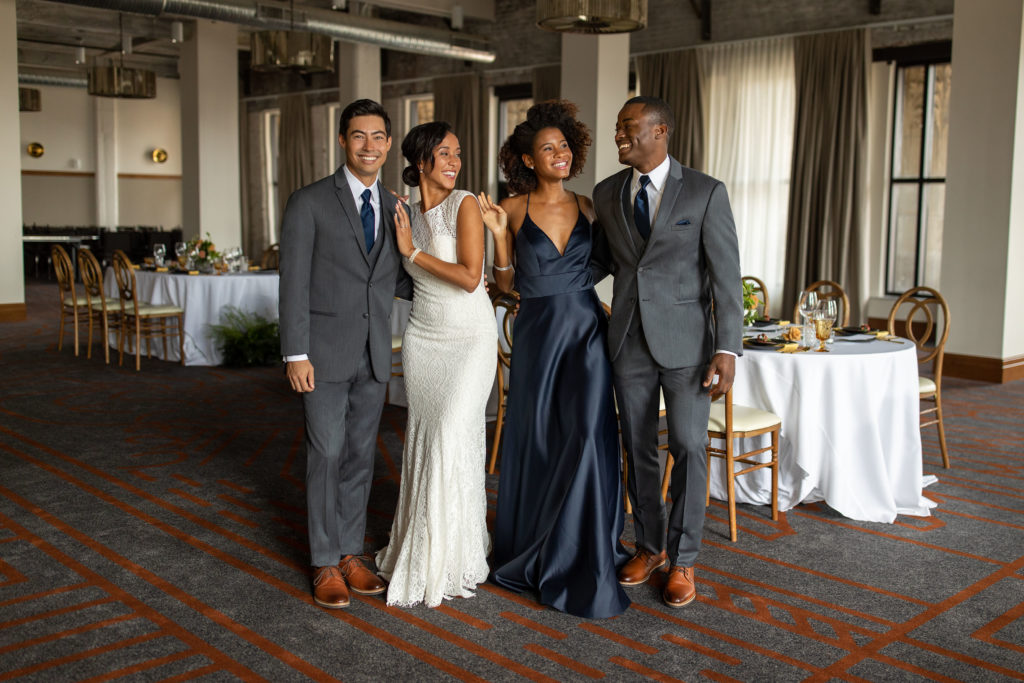 Two gorgeous wedding couples in elegant wedding suits, standing together